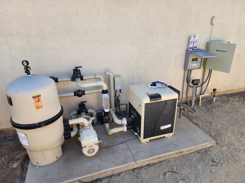 Pool equipment pad with a filter, pump, heater, and automation panel
